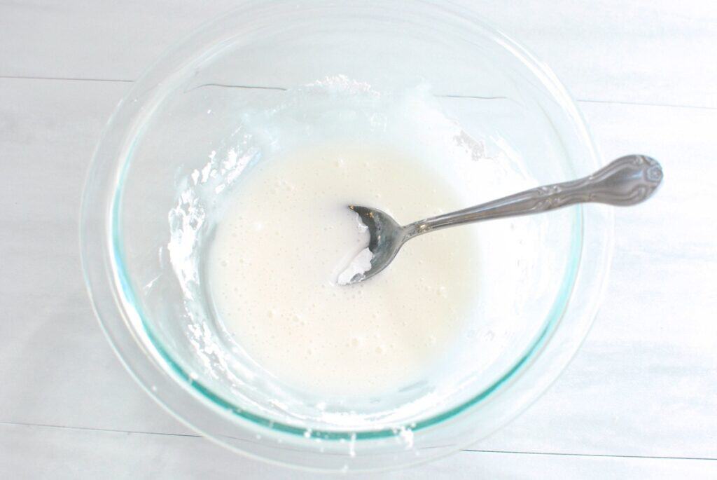 Powdered sugar glaze in a small glass bowl.