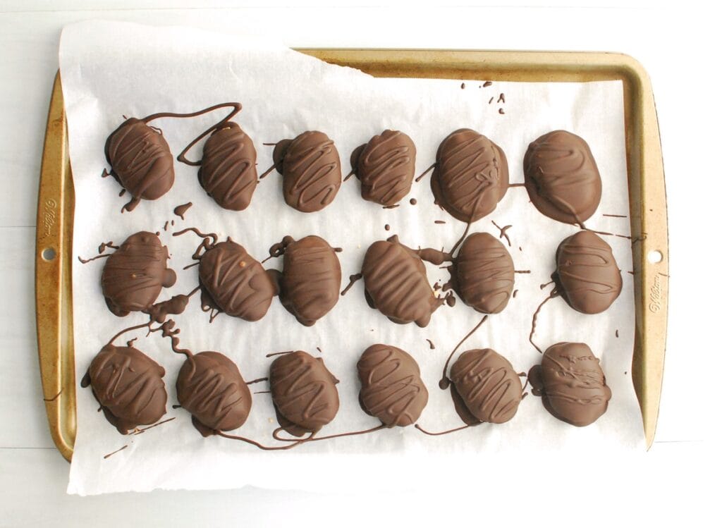 Chocolate peanut butter eggs with an extra drizzle of chocolate added on top.