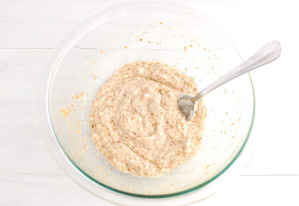 Softened dairy-free butter, sugar, vanilla, and a flax egg mixed together in a glass bowl.