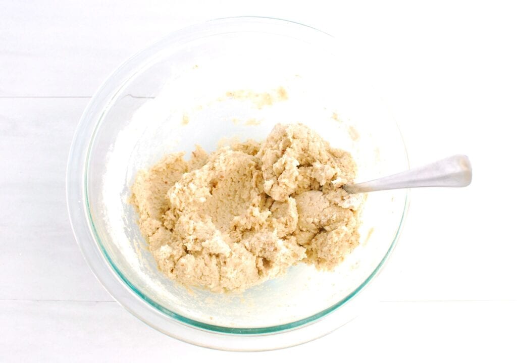 Cookie dough in a glass mixing bowl.
