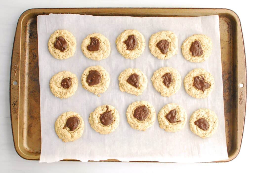 Just baked thumbprint cookies still on the baking sheet.