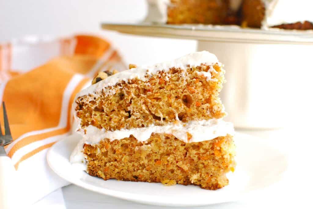 A close up of a piece of carrot cake showing the soft interior texture.