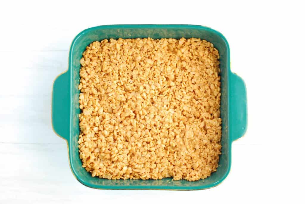 Peanut butter rice krispie treats pressed into the pan.