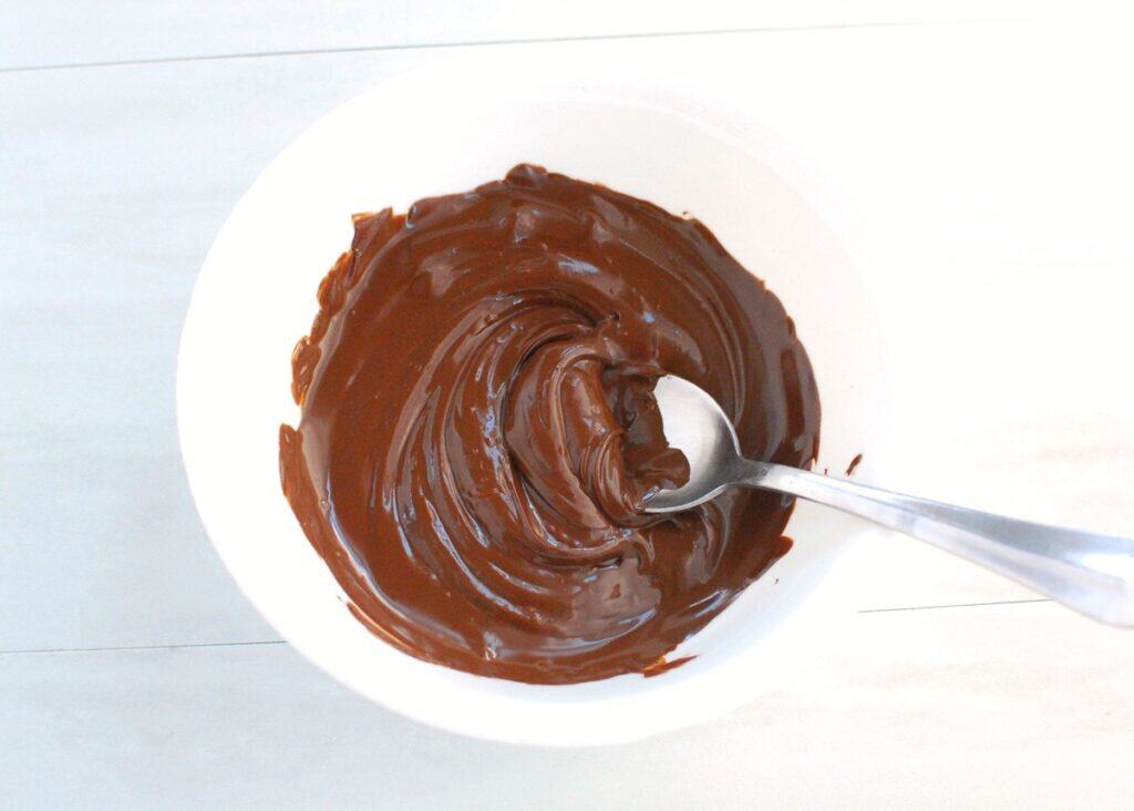 Melted chocolate in a white bowl.