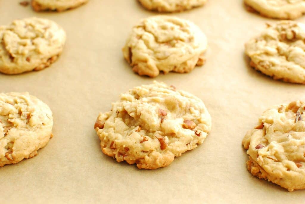 Butter pecan cookies on parchment paper.