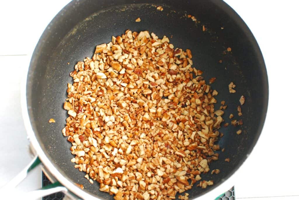 Pecans toasted in a pot.