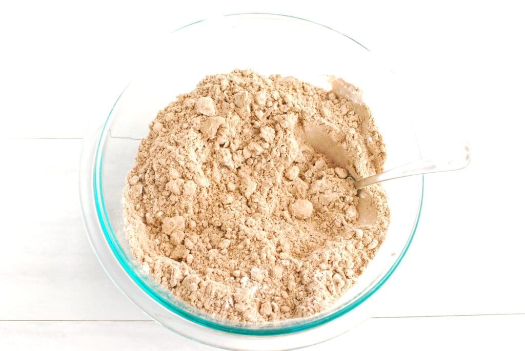 Brownie mix and flour mixed together in a glass bowl.