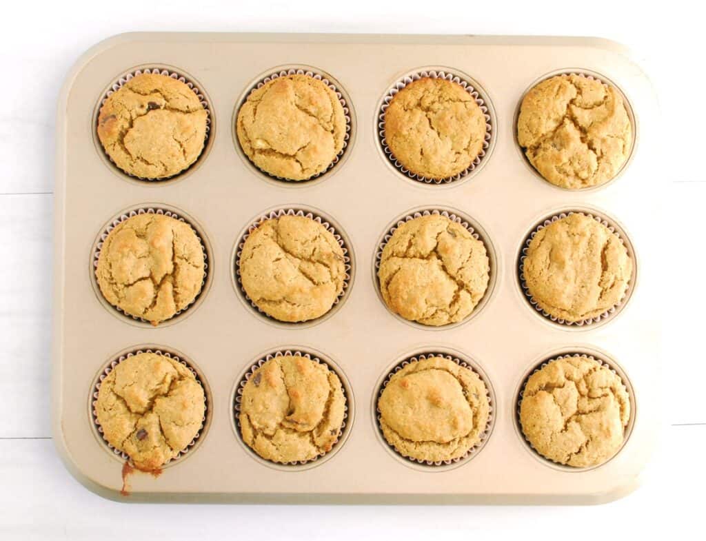 Just-baked banana protein muffins still in the muffin tin.