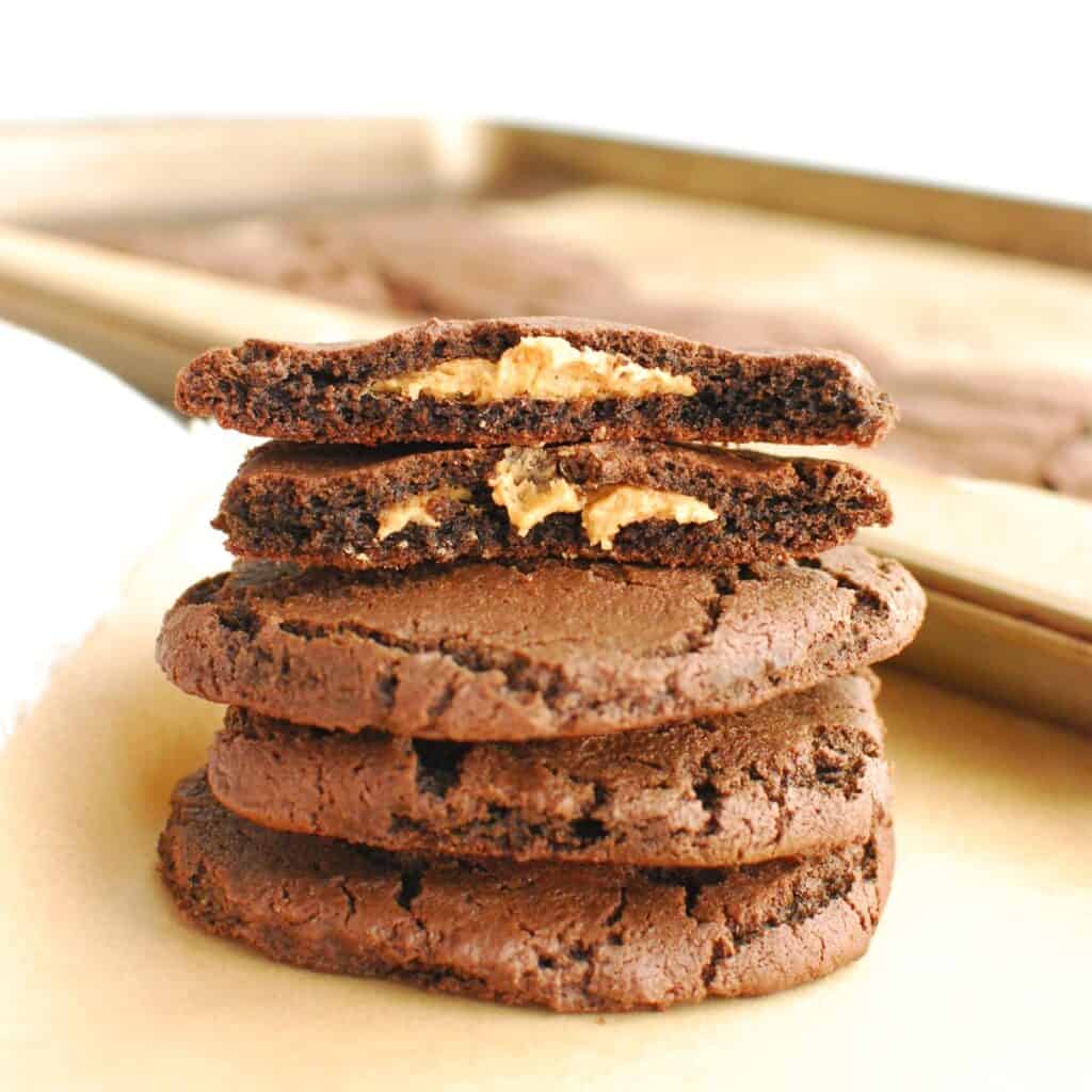 A stack of dairy free peanut butter stuffed chocolate cookies.