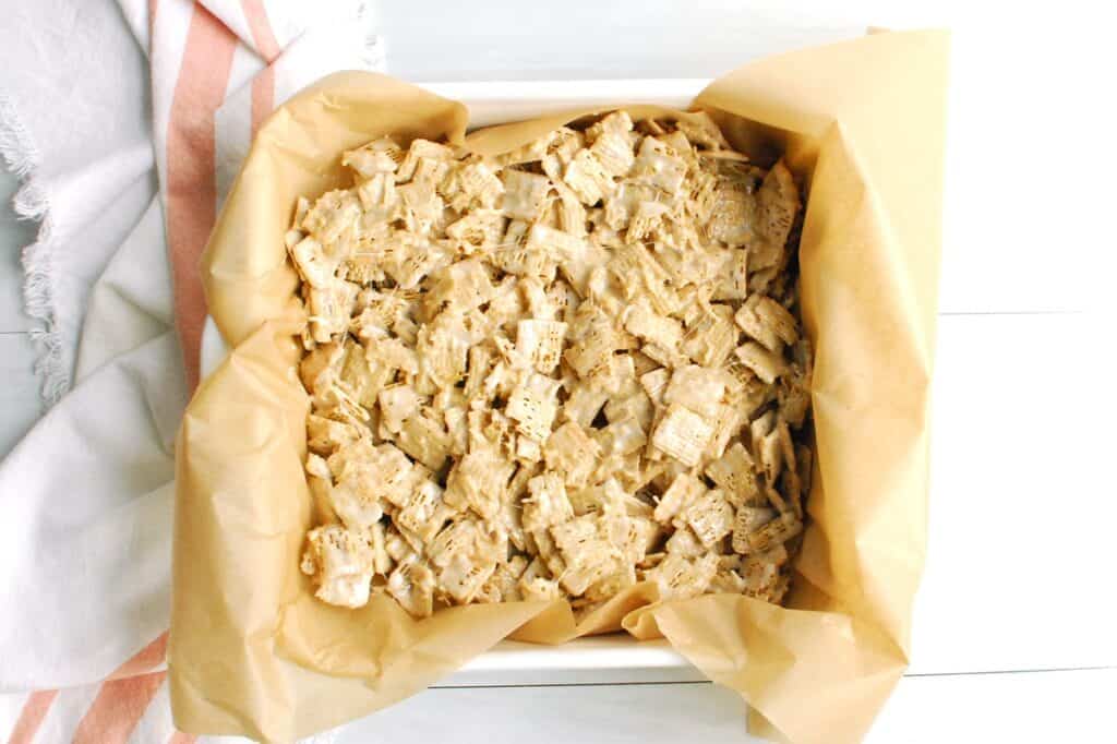 The marshmallow cereal mixture pressed into an 8x8 dish.