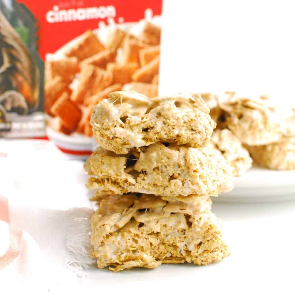 Several cinnamon life cereal treats stacked on top of each other.