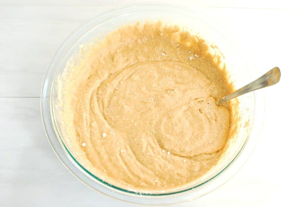 Cake mix and soda stirred together in a glass bowl.