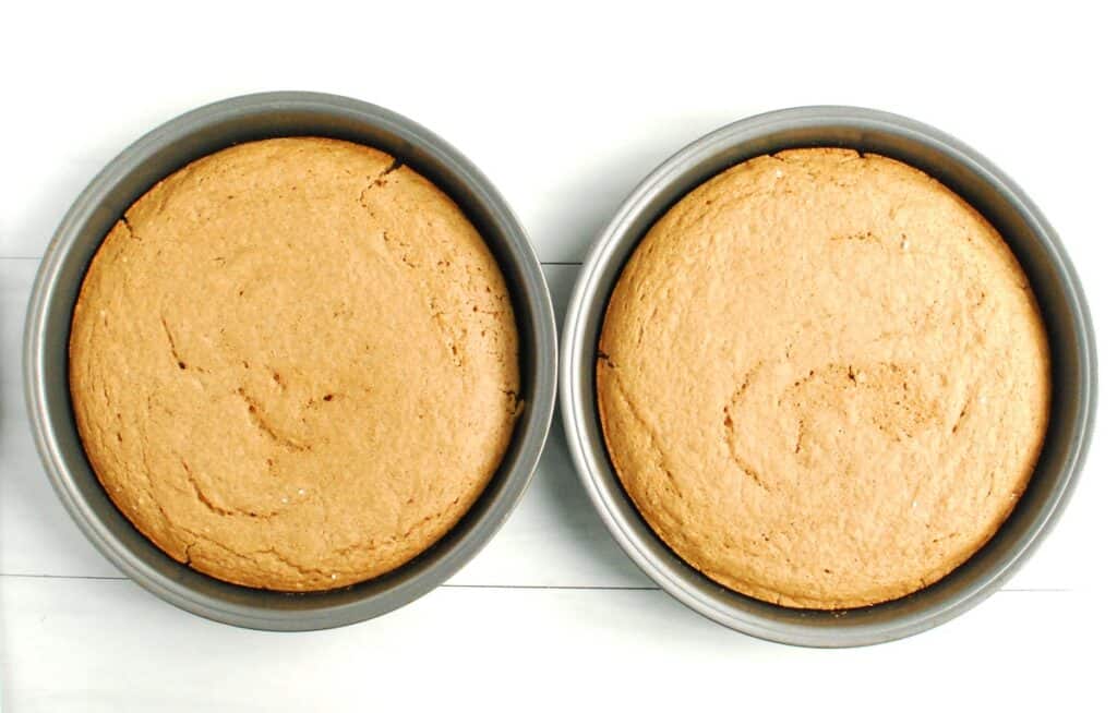 Two 8-inch cake rounds with just-baked spice cake.