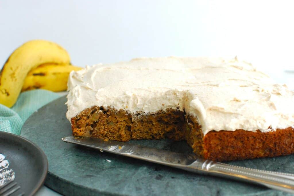 Dairy free banana cake with a slice cut from it.