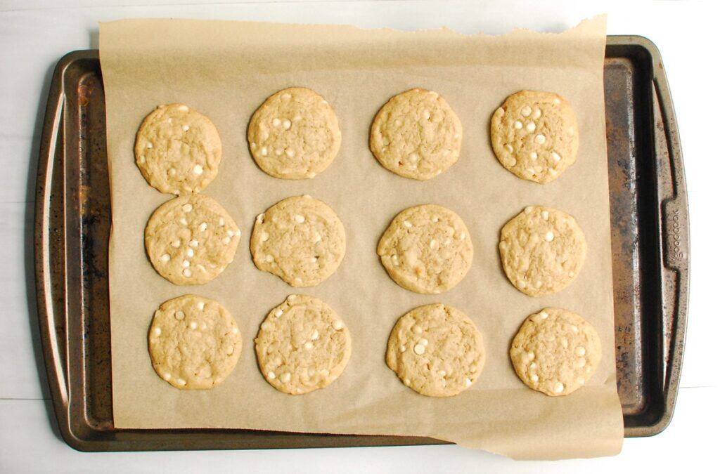Maple white chocolate cookies on a baking sheet.