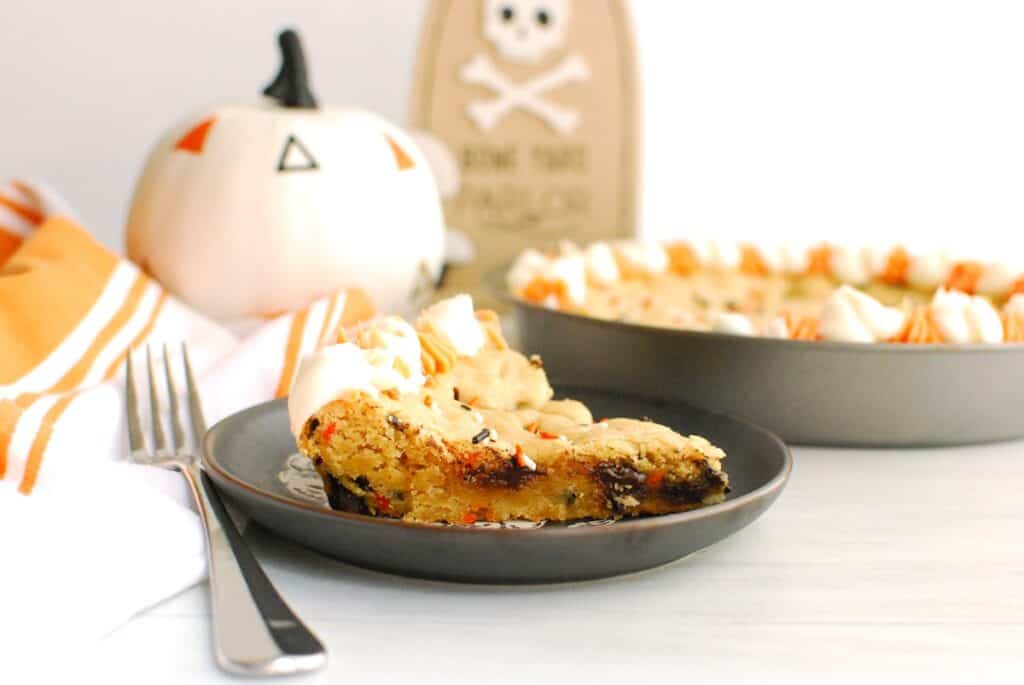 A slice of a dairy-free Halloween cookie cake on a plate.
