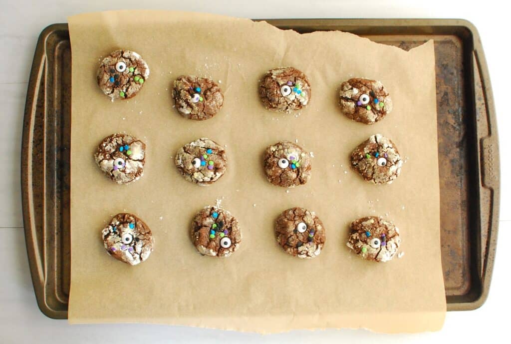 A baking sheet with chocolate pumpkin crinkle cookies.