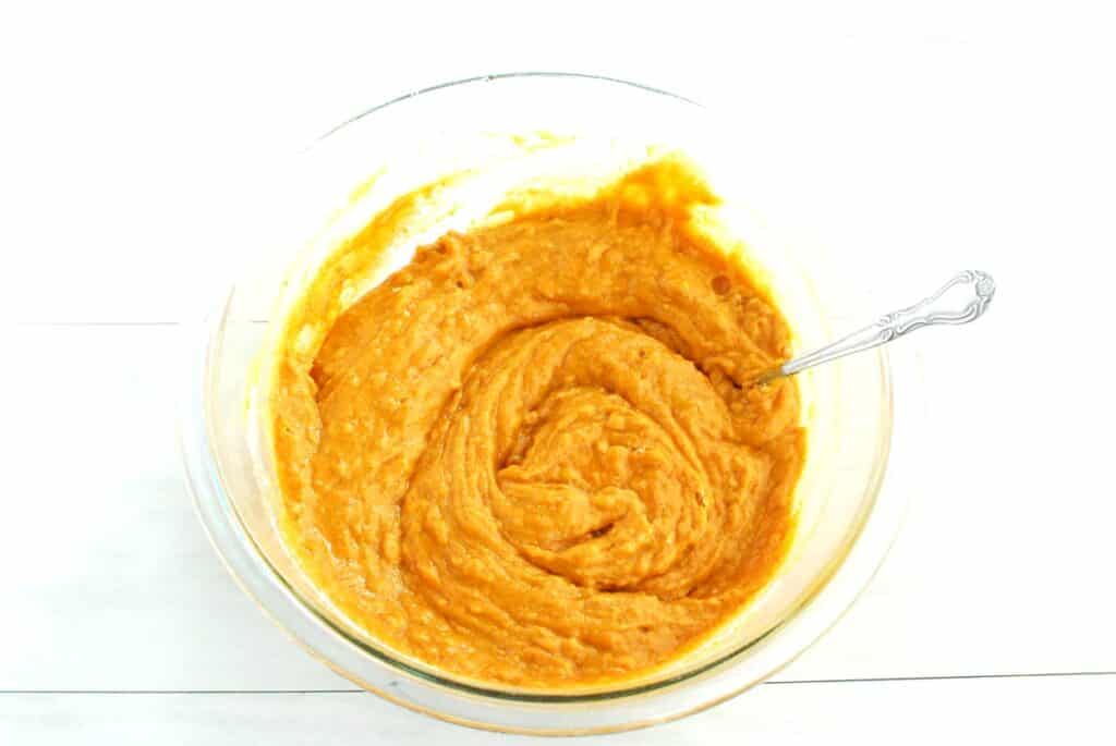 Pumpkin cupcake batter in a mixing bowl.