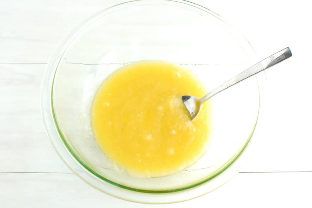 Sugar, olive oil, egg, and vanilla mixed together in a bowl.