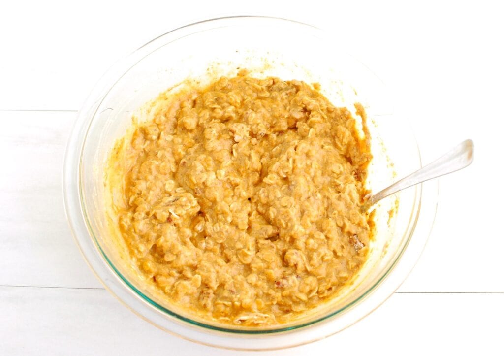 Baked oatmeal batter in a glass mixing bowl.