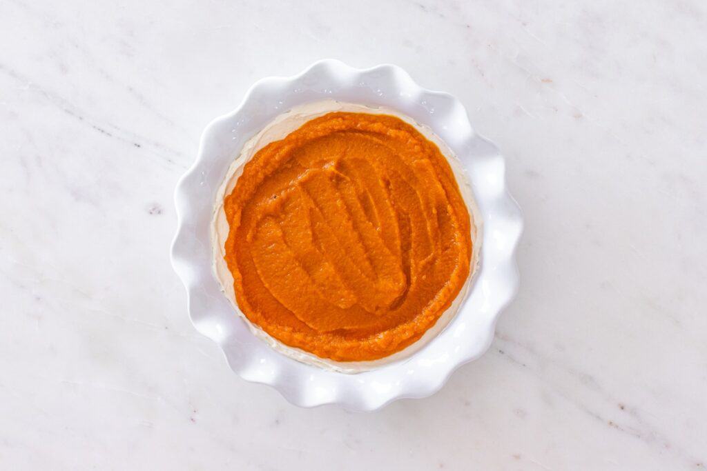 The pumpkin layer added to the pie plate.