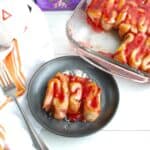 A Halloween guts-style cinnamon roll on a plate.
