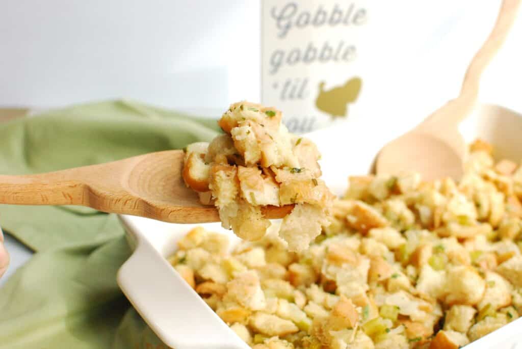 A spoonful of stuffing scooped out of the casserole dish.