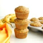 Three chia banana muffins stacked on top of each other.