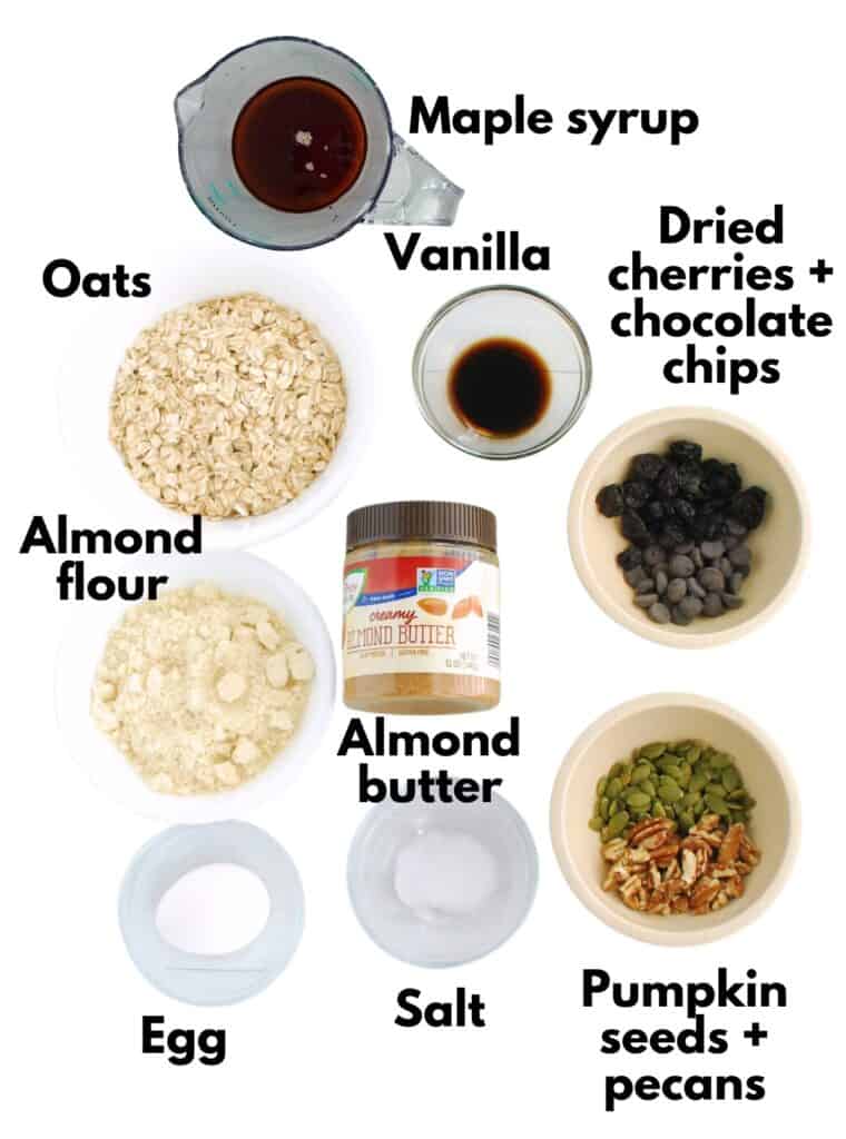 Maple syrup, oats, vanilla, chocolate, dried cherries, almond flour, almond butter, nuts, seeds, salt, and an egg.