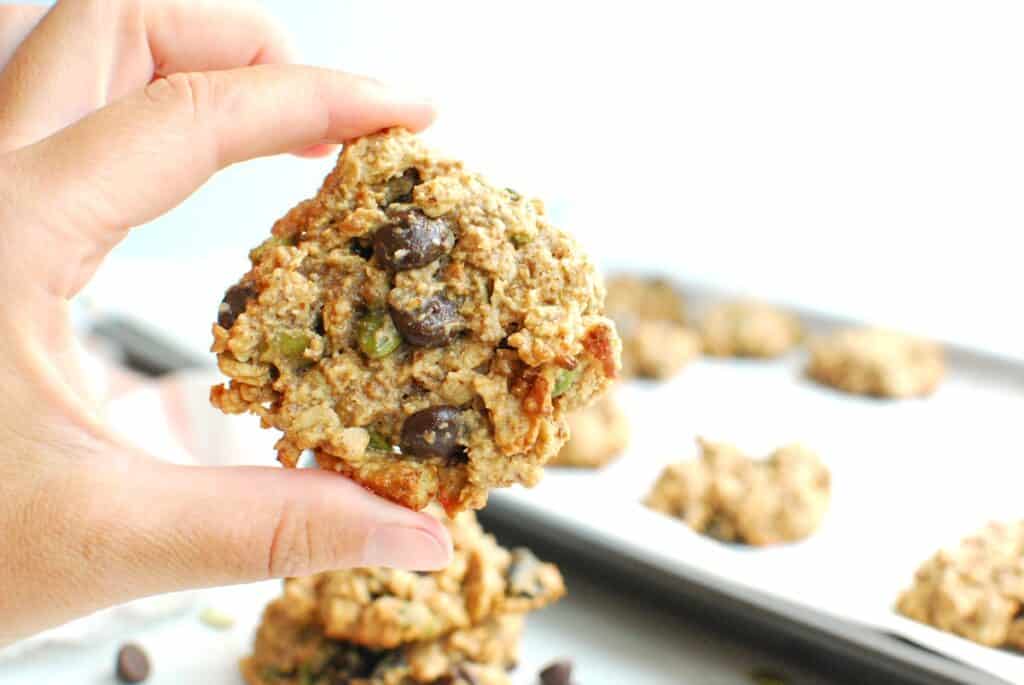 A hand holding a dairy free trail mix cookie.