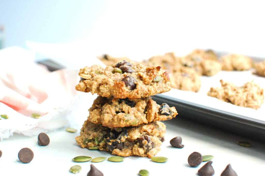 A stack of several trail mix cookies stacked on top of each other.