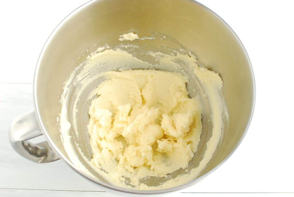 Dairy free butter and sugar creamed together in a silver mixing bowl.