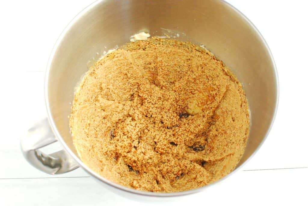 Squash, molasses, and vanilla mixed into the butter and sugar in a bowl.