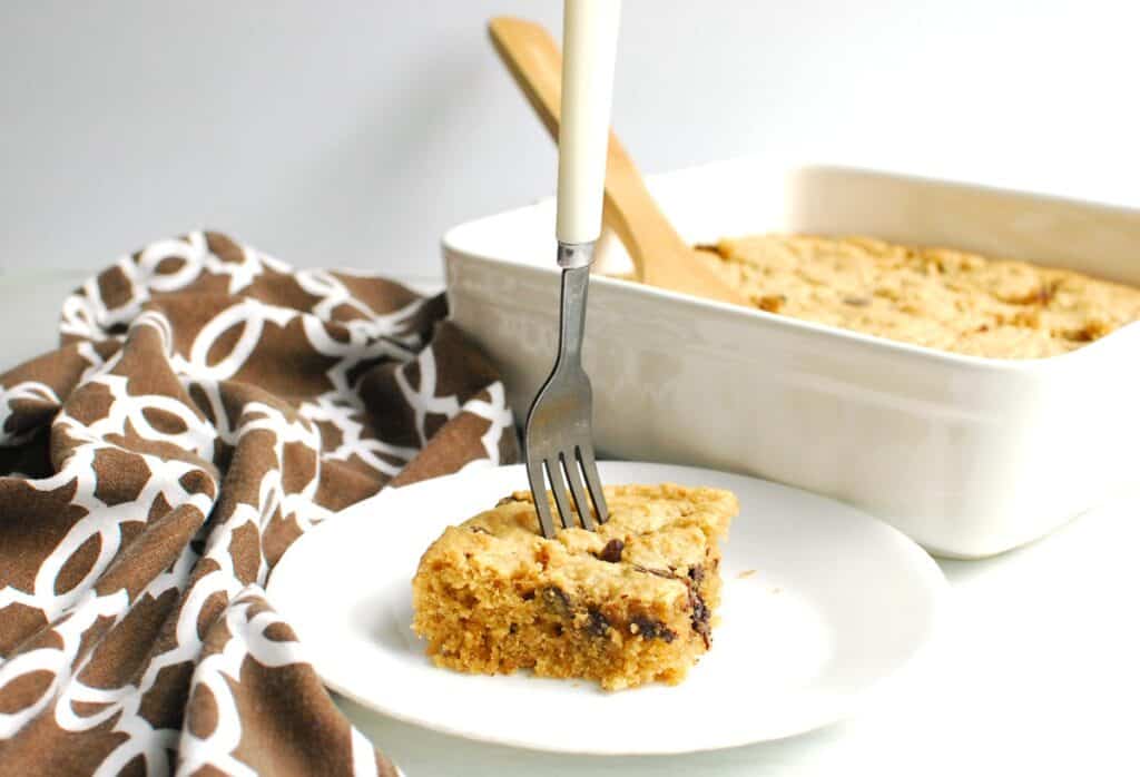 An almond flour chocolate chip bar with a fork stuck in the middle.