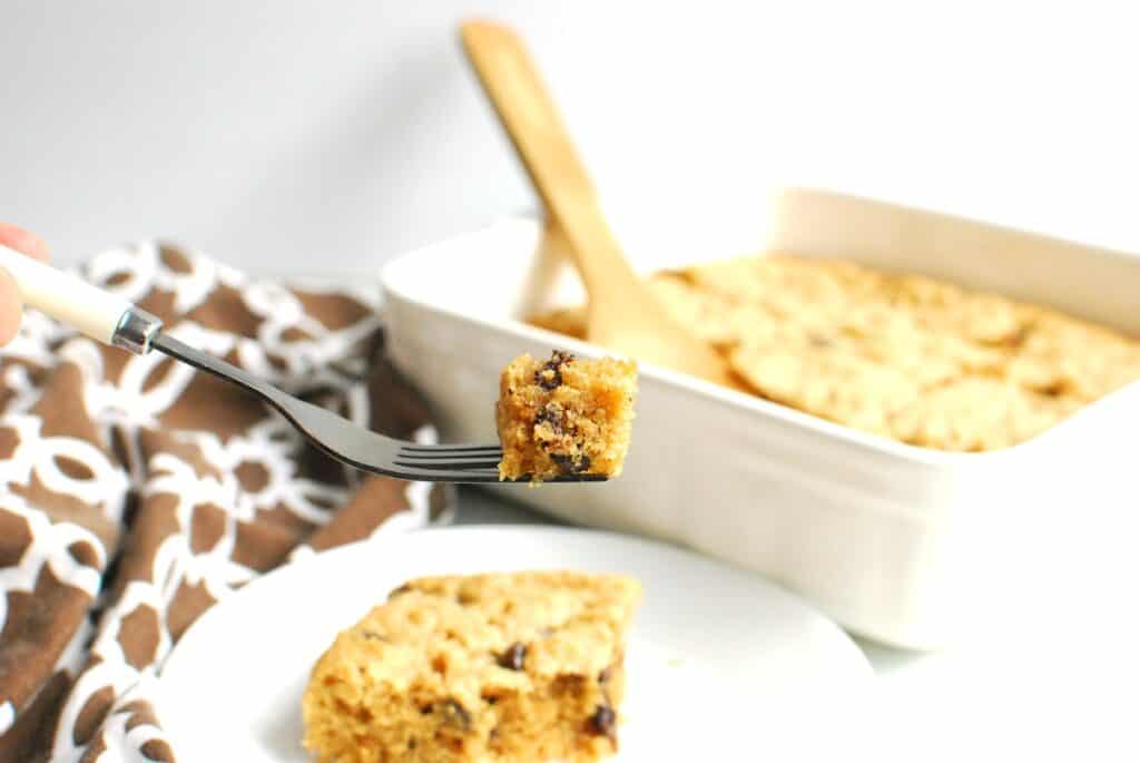 A fork with a bite of a chocolate chip bar on it.