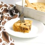 An almond flour chocolate chip bar on a plate with a fork stuck in it.