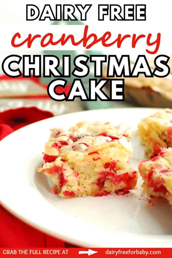A slice of dairy free cranberry Christmas cake with a text overlay with the name of the recipe.