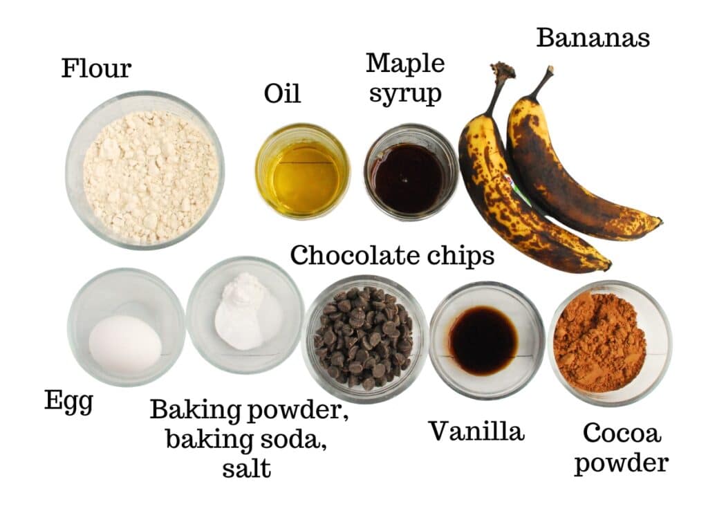 Bananas, maple syrup, oil, flour, egg, baking powder, baking soda, salt, chocolate chips, vanilla, and cocoa powder.