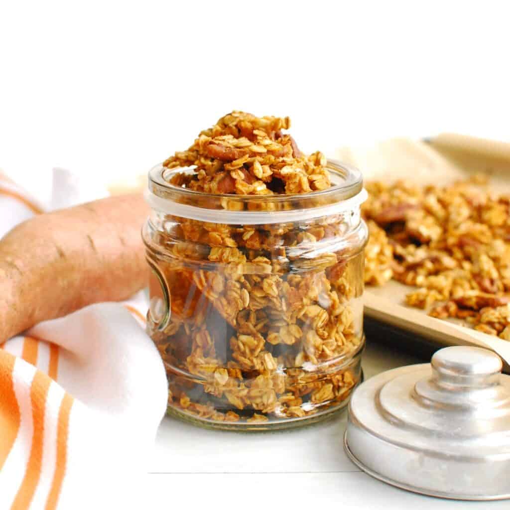Dairy free sweet potato granola in a small glass jar.