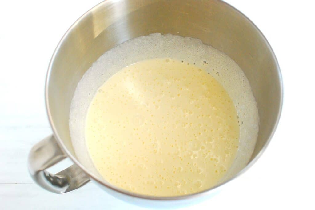 Sugar and eggs mixed together well in a mixing bowl.