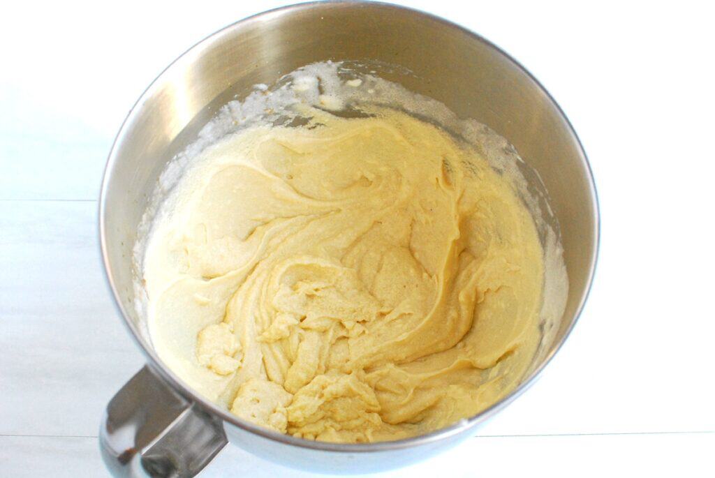 Dairy-free butter, vanilla, sugar, and eggs mixed together in a bowl.