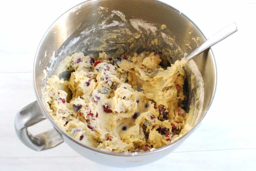 Cake batter in a silver mixing bowl.