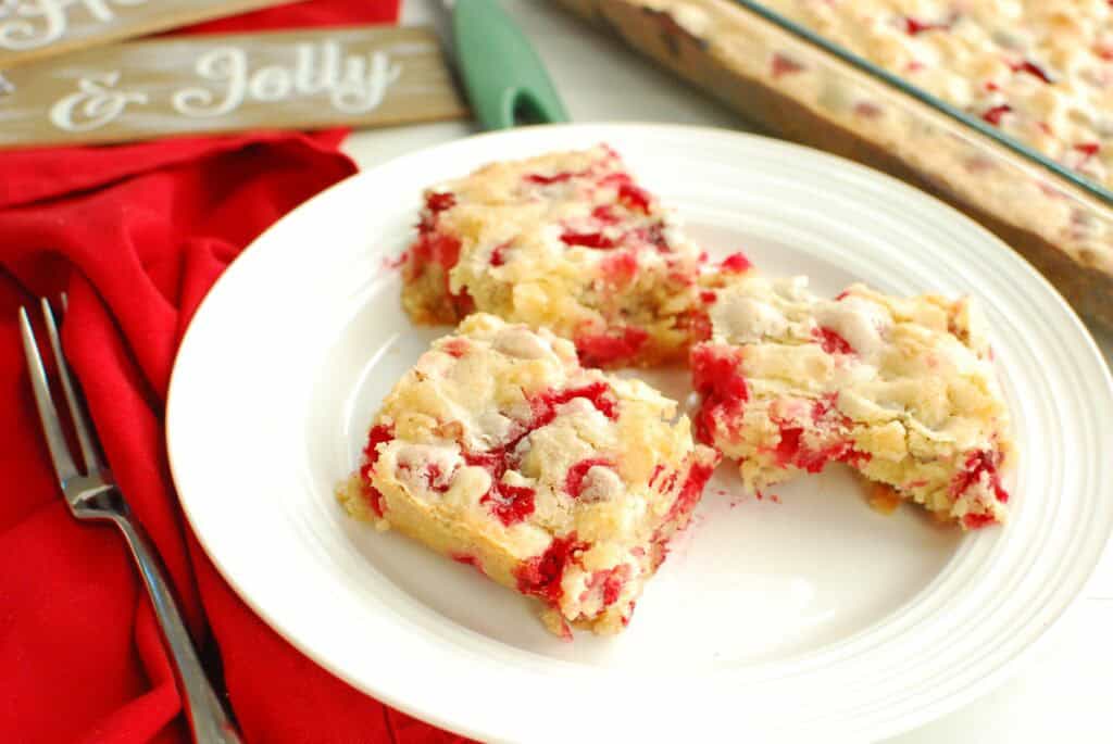 Three slices of dairy-free cranberry Christmas cake on a plate.