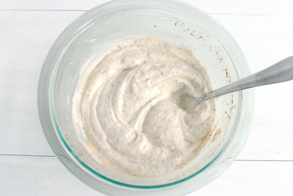 Dressing ingredients mixed together in a glass bowl.