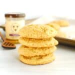 A stack of four dairy-free honey cornmeal cookies.