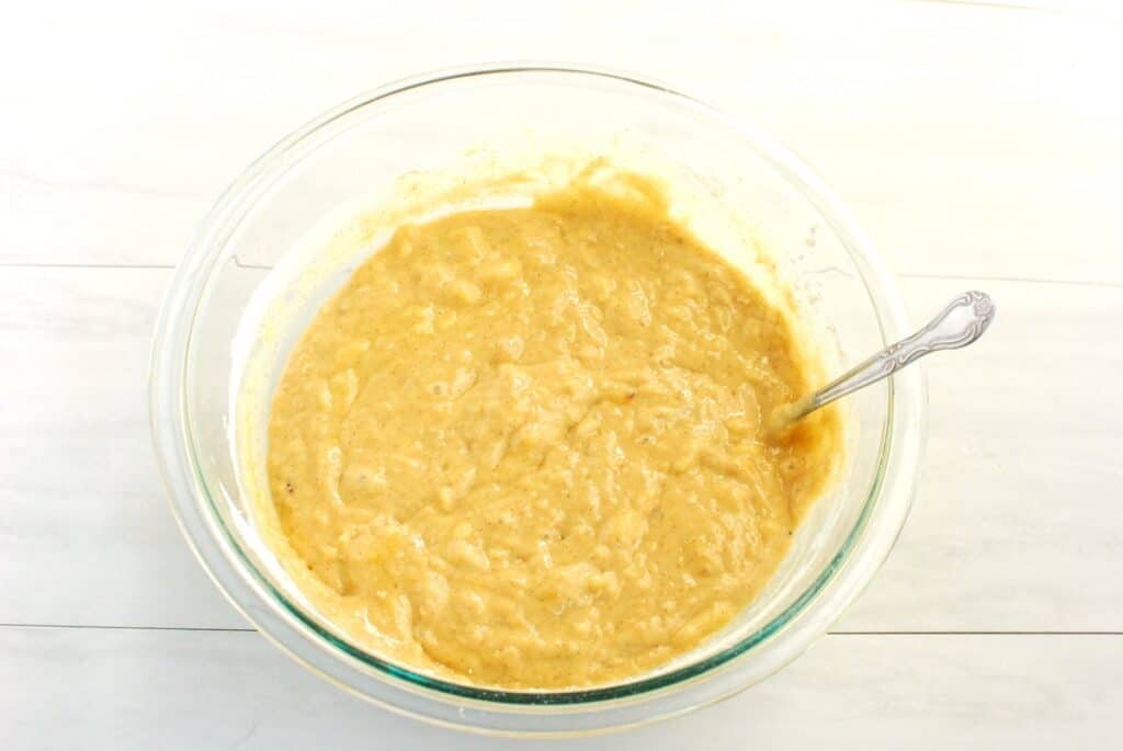 All the ingredients mixed together for plantain bread batter in a glass bowl.