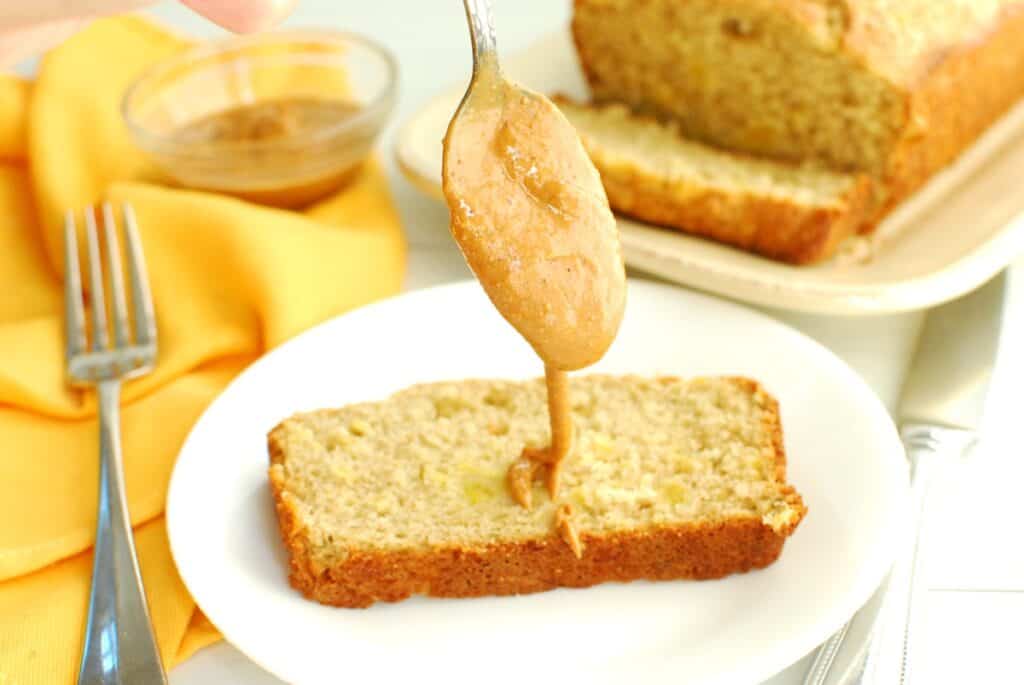 Peanut butter drizzled on a slice of plantain bread.