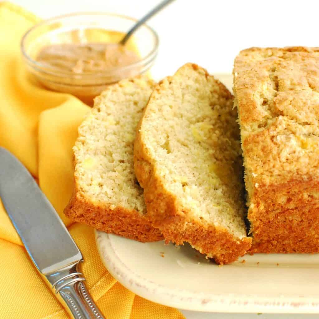 A loaf of plantain bread with two slices cut from the loaf.
