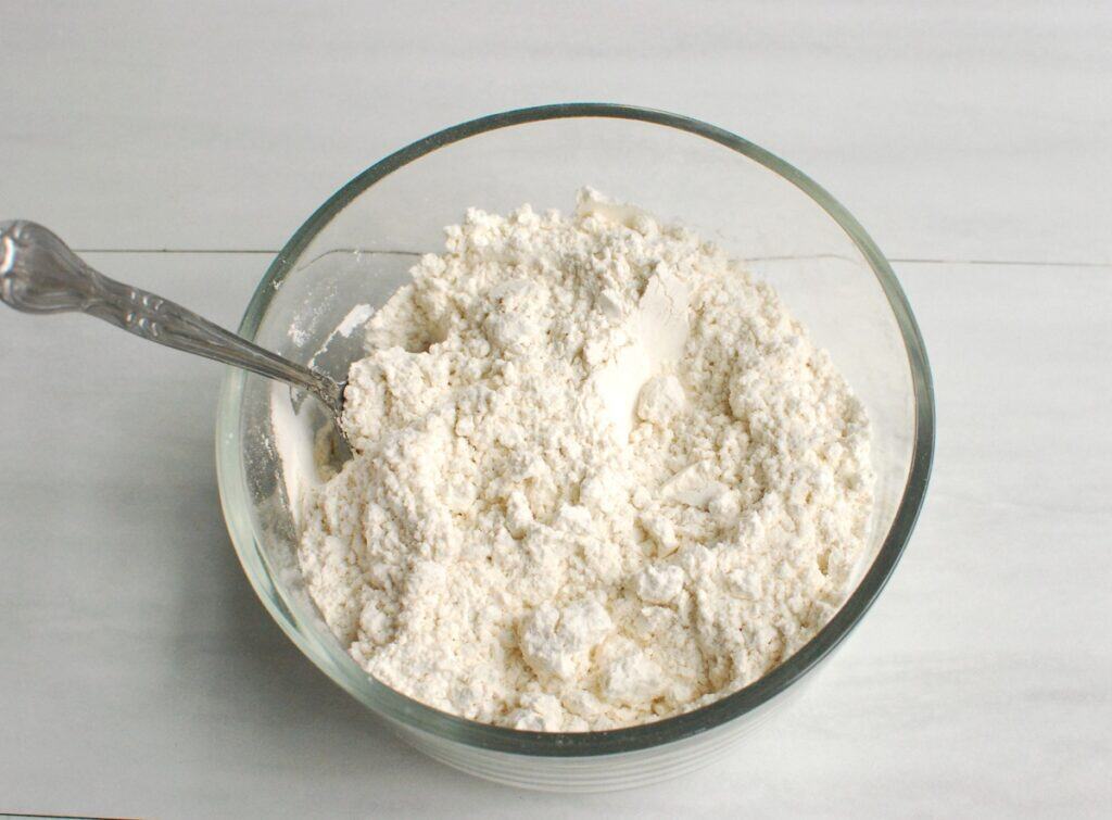 Flour, salt, and baking soda mixed together in a bowl.