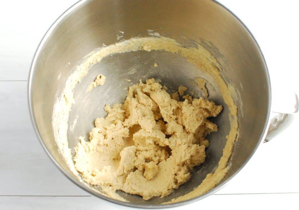 Dairy free butter, sugar, and brown sugar mixed together in a silver bowl.